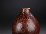 brown and black vase on a black background with a black background