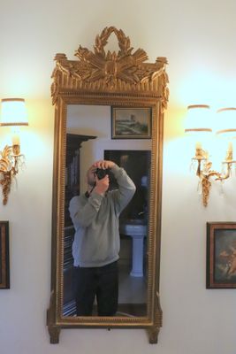 a man taking a picture of himself in the mirror