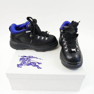 a pair of black shoes on a white box
