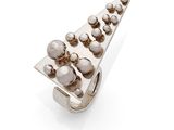 a close up of a metal object on a white surface