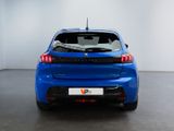 the rear end of a blue car in a white room