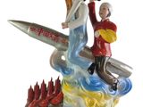 a figurine of a man and a woman on a surfboard