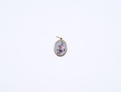 a close up of a small pendant with a flower design on it
