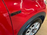 a close up of a red car with a sticker on it
