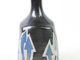 a black vase with a blue and white design on it