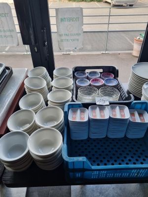 a lot of plates and bowls on the table