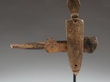 a wooden sculpture of a knife on a black stand
