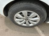 a close up of a tire on a car in a parking lot
