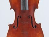 an old violin sitting on top of a stand on a white surface