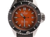an orange and black watch on a white background with a white background