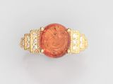 une image représentant une bague en or sertie d'une pierre rouge et de diamants