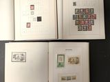 two pages of a book with stamps on them sitting on a table