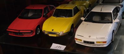 Plusieurs petites voitures sont exposées dans une vitrine.
