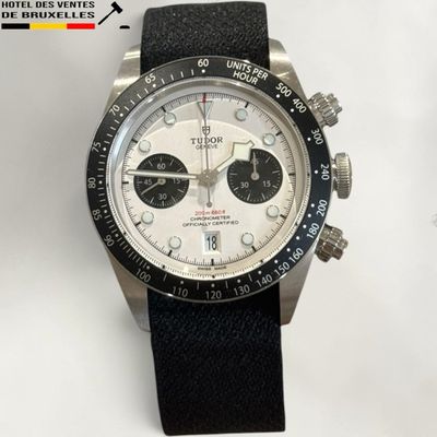 rolex watch with black strap and white dial on white background