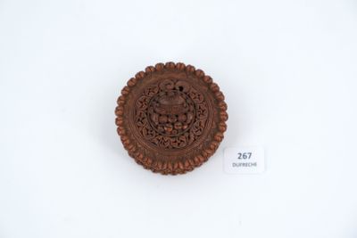 an image of a small carved object on a white surface
