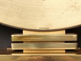 a clock that is on top of a wooden stand