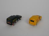 two toy cars that are sitting next to each other on a table