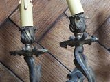 two candles that are sitting on a wooden table