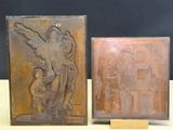 pair of bronze plaques of a woman and child on a table