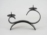 pair of black metal candlesticks on a white background