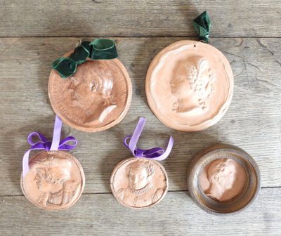 four different types of clay ornaments on a wooden table