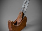 a close up of a planer with a wooden handle on a gray background