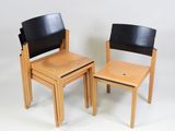 two wooden chairs and a small table on a white background