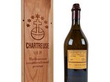 the bottle of wine is next to a wooden box
