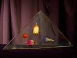 a glass pyramid that has different objects inside of it