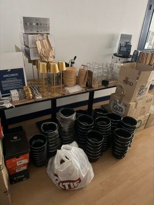 a table with a lot of cups and other items on it