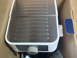 a box with a toaster inside of it on the floor