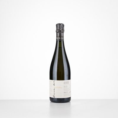 a bottle of wine sitting on top of a white table