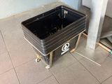a black trash can sitting on the floor in a room