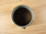a cup of coffee sitting on a wooden table