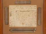 an old piece of paper with writing on it in a wooden frame