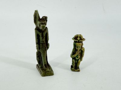 two figurines of a man and a woman standing next to each other