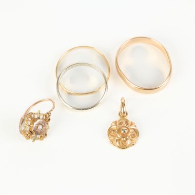 three gold rings and a ring with a diamond on it
