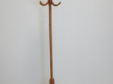 an image of a wooden coat stand with a coat rack on top of it