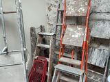 many ladders that are leaning against the wall