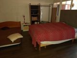 a bedroom with a bed and a chair in it