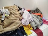 a pile of clothes sitting on top of a washing machine