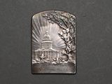 a silver medal with a picture of the capitol building on it