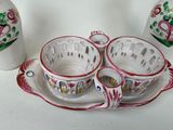 three cups and a saucer on a tray