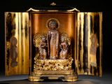 a golden statue of a buddha in a gold case