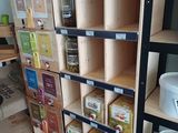 a wooden shelf with various items on it in a store