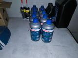 many bottles of water sitting on a counter next to a box
