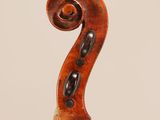 an antique violin with a scroll on the back of it