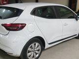 the rear end of a white car parked in a garage