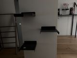 a black and white shelf in the corner of a room