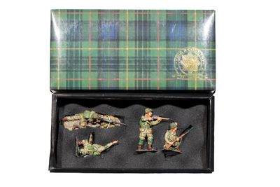 four figurines of soldiers in a black box